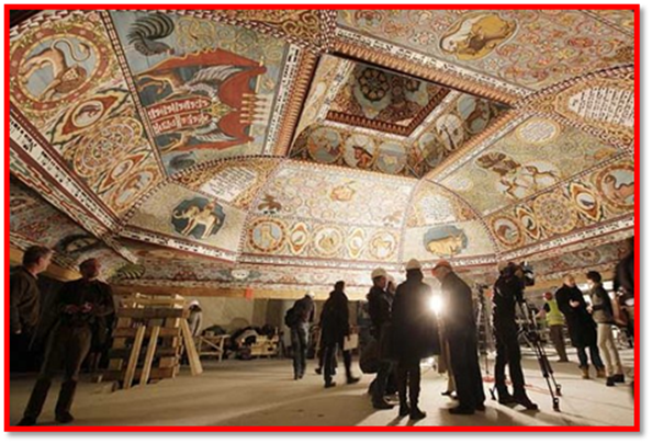 People look at the the painted ceiling of a reconstructed wooden synagogue that dates back centuries during a presentation of it to the media in Warsaw, Poland, on Tuesday March 12, 2013. The reconstructed ceiling and roof of the 17th century synagogue is a key attraction in the Museum of the History of Polish Jews, a major institution due to open next year in  Warsaw.(AP Photo/Czarek Sokolowski)